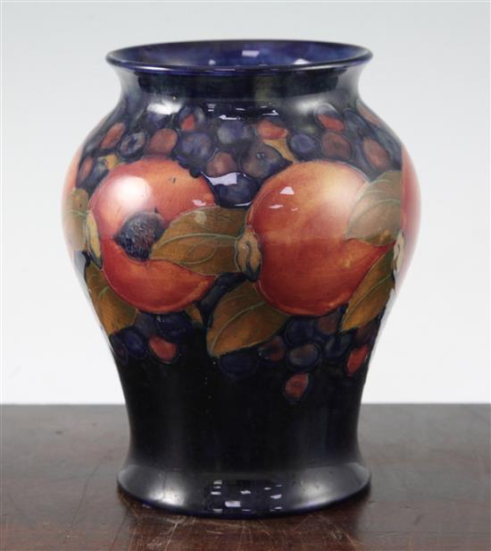 Two William Moorcroft pomegranate pattern vases, c.1916-25, 19cm, latter heavily repaired